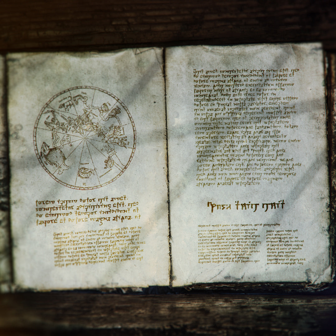 A fictional spell book lays open and filled with strange markings, used as a promotional image for the arcane cipher font