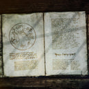 A fictional spell book lays open and filled with strange markings, used as a promotional image for the arcane cipher font