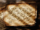 Vintage parchment with handwritten text and warm, amber light cast from a nearby window