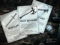 three RPG item cards lay on a table, each has an illustration of a weapon or item for a ttrpg game and the text is set using the Adderbite distressed font 