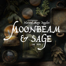 The words Moonbeam & Sage are written in white against an earthy toned flatlay showing herbs and candles