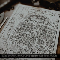 Map of a fantasy village printed on paper and laid out on a dungeon masters desk