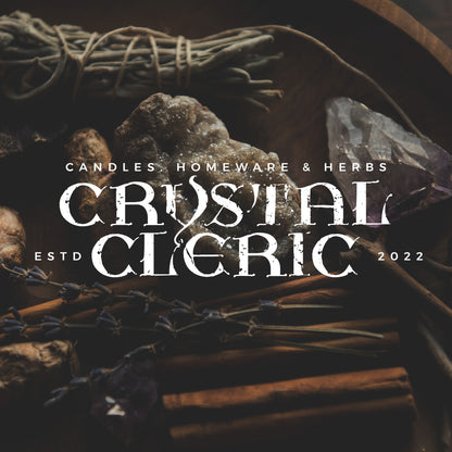 The words Crystal Cleric set in white using the ghregor font against a dark image of crystals and herbs