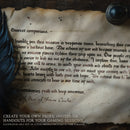 A scroll letter prop on a wooden desk with a quill and inkwell sitting on top