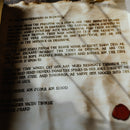 An ancient looking scroll filled with fictional writing, looks almost roman, used as a prop for a d&d campaign