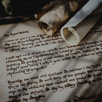 Old letter and scrolls on a wooden background, the writing looks very medieval and gothic