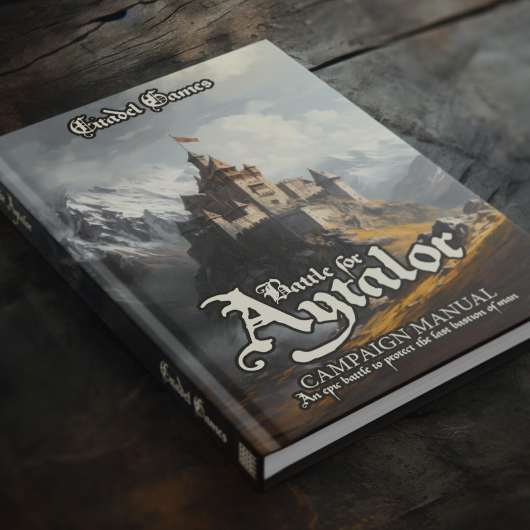 A hardback book sits on a dark wooden table. It is a supplement to a ttrpg and has a fantastical image of a castle on the front and the name Battle for Aytalor written using the Spellbinder gothic font