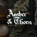 A promotional image for the Spellbinder font it shows an image of a botanists table slightly blurred with the name Amber & Thorn written in white on top