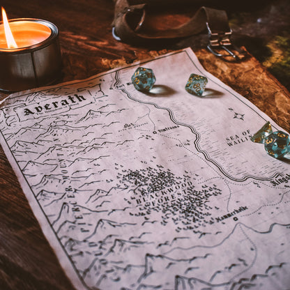 photo of a fantasy map on a table with candle and DnD dice