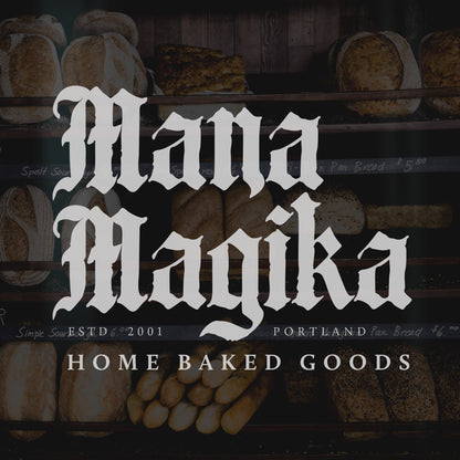 dark image of a bakery window with Mana Magika written in white using the candelabra font