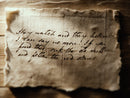 Vintage paper with handwritten text on an old desk, used as a prop for a dungeons and dragons game session