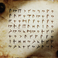 An archaic sheet of paper is covered writing that looks ragged and scrawled and not entirely human