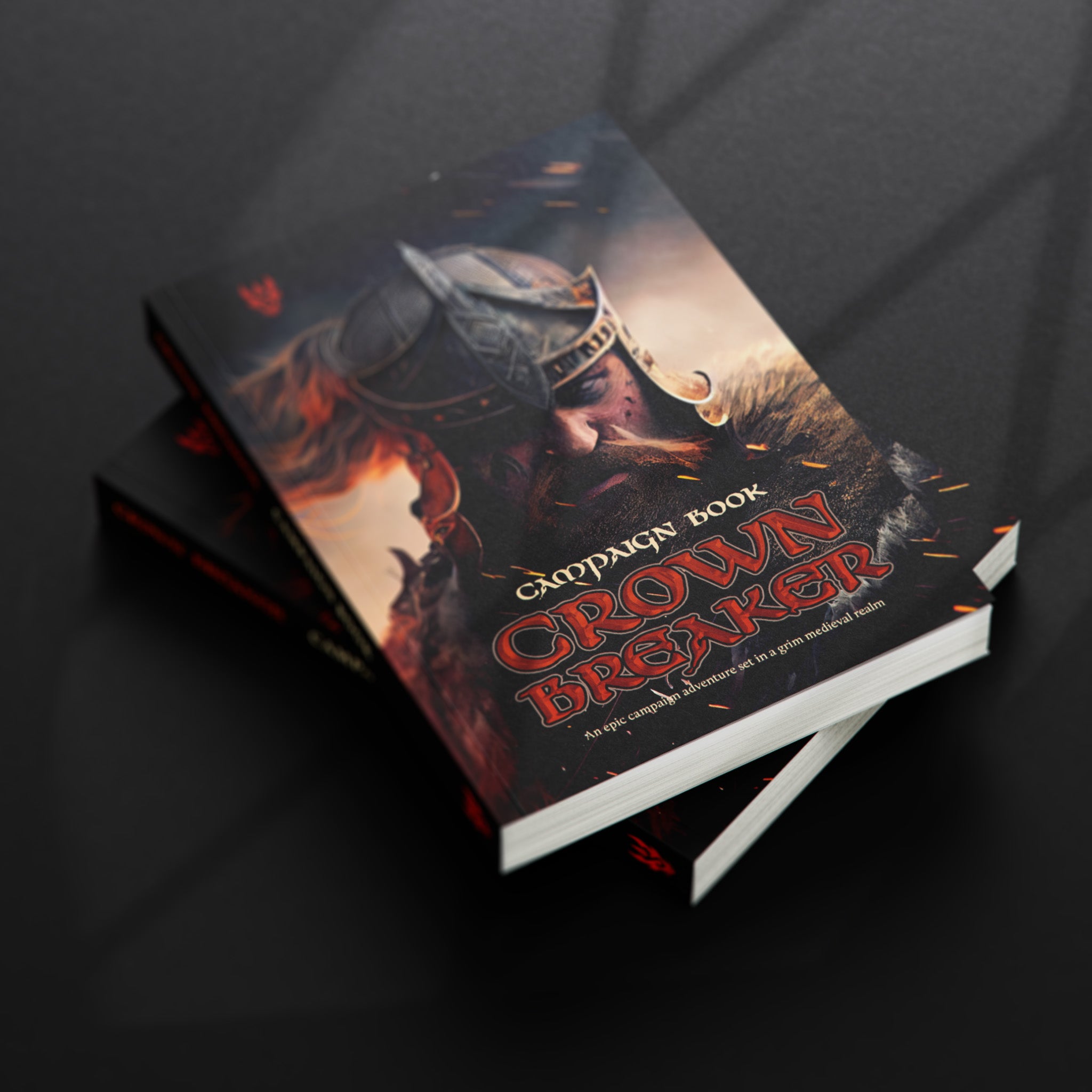 Two roleplaying campaign books on top of each other on a black desk 