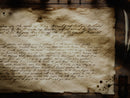 Old medieval looking document with text on a wooden surface